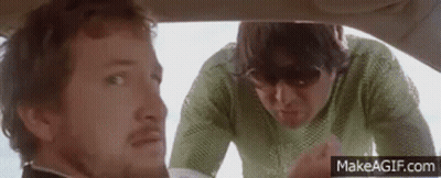 A Man And A Woman Are Sitting In A Car . GIF