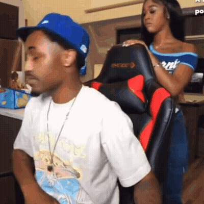 A Man And A Woman Are Sitting In A Chair . GIF