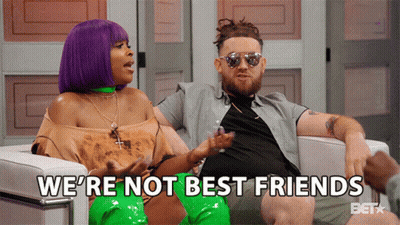 A Man And A Woman Are Sitting In A Chair With The Words We 'Re Not Best Friends Behind Them GIF
