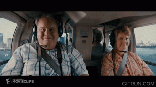 Man And Woman In Helicopter With Fandango Ad GIF