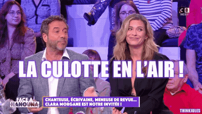 A Man And A Woman Are Sitting In Front Of A Crowd And The Words La Culotte En L' Air Are On The Screen GIF