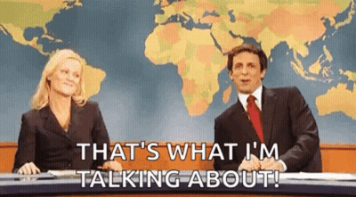 A Man And A Woman Are Sitting In Front Of A Map Of The World Talking About Something . GIF