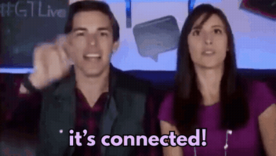 A Man And A Woman Are Sitting In Front Of A Sign That Says It 'S Connected .. GIF