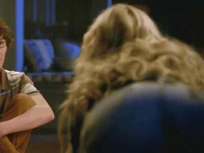 A Man And A Woman Are Sitting Next To Each Other And The Woman Has Long Blonde Hair GIF