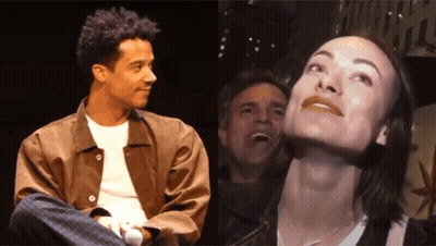 A Man And A Woman Are Sitting Next To Each Other And The Woman Is Smiling GIF
