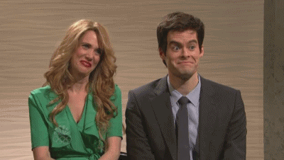 A Man And A Woman Are Sitting Next To Each Other And The Woman Is Wearing A Green Dress . GIF