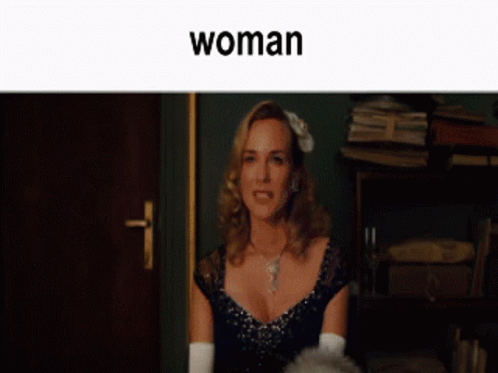 A Man And A Woman Are Sitting Next To Each Other And The Word Woman Is On The Bottom GIF