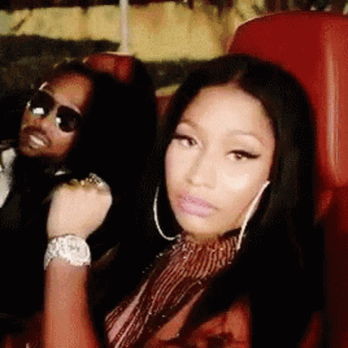 A Man And A Woman Are Sitting Next To Each Other In A Car . GIF