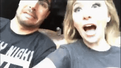 A Man And A Woman Are Sitting Next To Each Other In A Car And The Woman Is Screaming . GIF