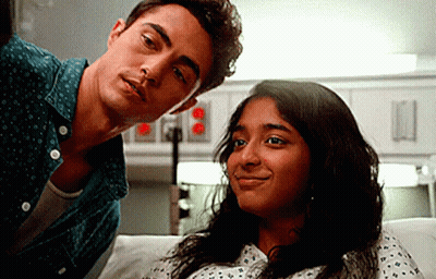 A Man And A Woman Are Sitting Next To Each Other In A Hospital Room . GIF