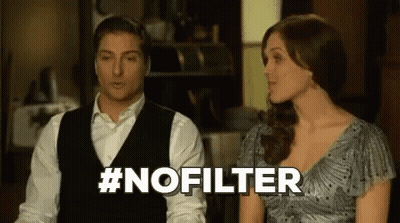 A Man And A Woman Are Sitting Next To Each Other In A Room And The Woman Is Talking To The Man . GIF