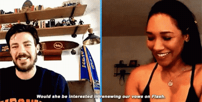 A Man And A Woman Are Sitting Next To Each Other In A Room . GIF