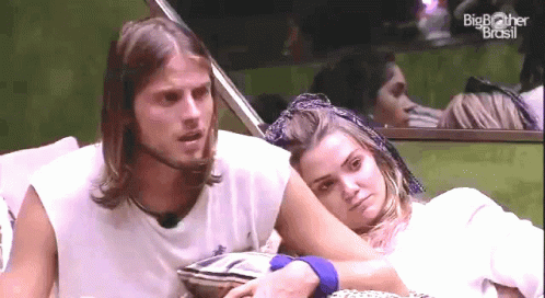 Man And Woman Sitting In Front Of Big Brother Brasil GIF
