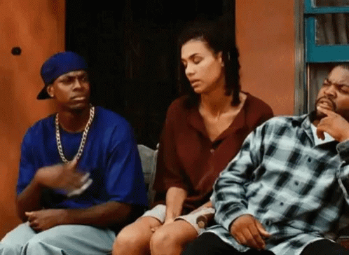 A Man And A Woman Are Sitting Next To Each Other On A Bench . GIF