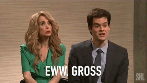 A Man And A Woman Are Sitting Next To Each Other On A Stage . The Woman Is Wearing A Green Dress . GIF