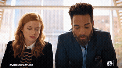 A Man And A Woman Are Sitting Next To Each Other With A Nbc Logo In The Corner GIF