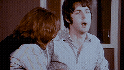 A Man And A Woman Are Sitting Next To Each Other With The Man Making A Funny Face GIF