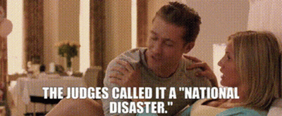 A Man And A Woman Are Sitting Next To Each Other With The Words " The Judges Called It A National Disaster " GIF