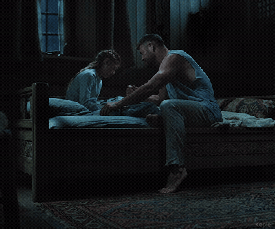A Man And A Woman Are Sitting On A Bed In A Dark Room With The Word Kepler In The Corner GIF