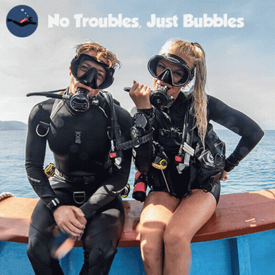 A Man And A Woman Are Sitting On A Boat With The Words " No Troubles Just Bubbles " Behind Them GIF