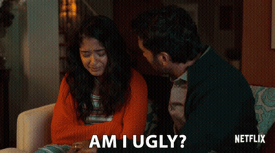 A Man And A Woman Are Sitting On A Couch And The Man Asks The Woman If She Is Ugly GIF