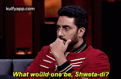 A Man And A Woman Are Sitting On A Couch And The Man Is Asking The Woman What Would One Be . GIF