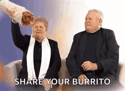 A Man And A Woman Are Sitting On A Couch And The Woman Is Holding A Large Burrito . GIF