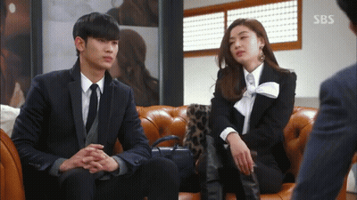 A Man And A Woman Are Sitting On A Couch With Sbs Written On The Bottom GIF