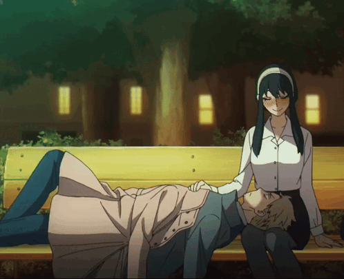 A Man And A Woman Are Sitting On A Park Bench GIF