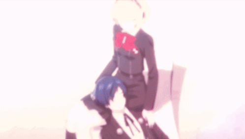 A Man And A Woman Are Sitting On A White Chair GIF