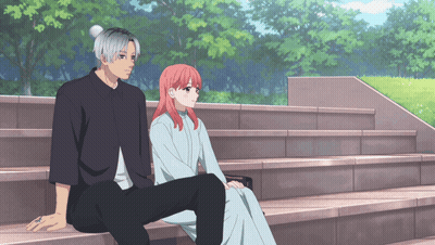 A Man And A Woman Are Sitting On Stairs Looking At Each Other GIF