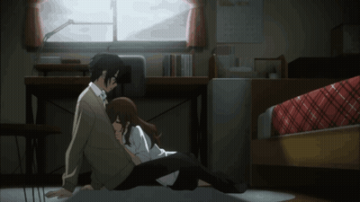 A Man And A Woman Are Sitting On The Floor Hugging Each Other GIF
