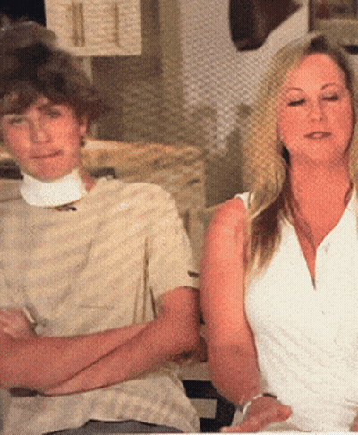 a man and a woman are sitting with their arms crossed
