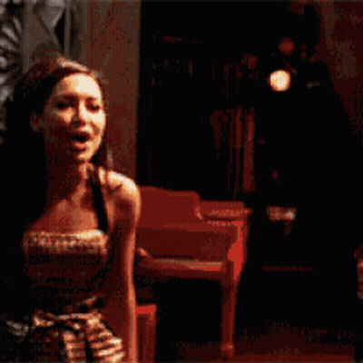 A Man And A Woman Are Smiling At Each Other GIF