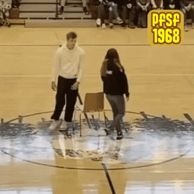 A Man And A Woman Are Standing In A Circle On A Basketball Court With The Year 1968 On The Bottom GIF
