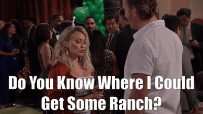 A Man And A Woman Are Standing In A Crowd And The Man Asks The Woman Where She Could Get Some Ranch GIF