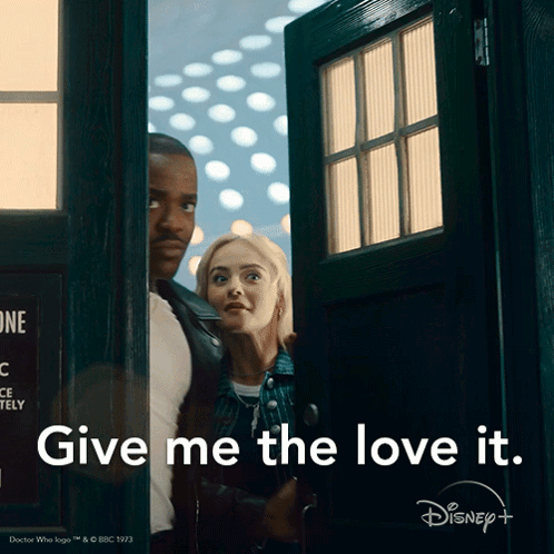 A Man And A Woman Are Standing In A Doorway With The Words Give Me The Love It Above Them GIF