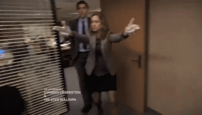 A Man And A Woman Are Standing In A Hallway With The Name Warren Lieberstein On The Bottom Of The Screen GIF