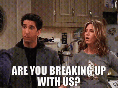 A Man And A Woman Are Standing In A Kitchen With The Words " Are You Breaking Up With Us " GIF