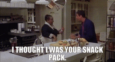 A Man And A Woman Are Standing In A Kitchen With The Words I Thought I Was Your Snack Pack . GIF