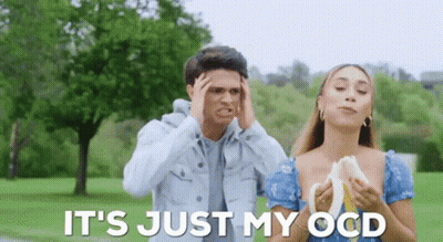 A Man And A Woman Are Standing In A Park And The Woman Is Holding A Banana . GIF