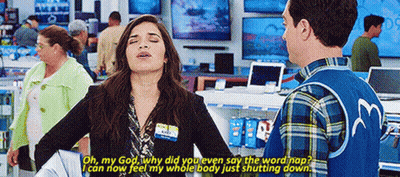 A Man And A Woman Are Standing In A Store Talking . GIF