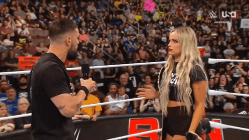 Man And Woman Talking In Wrestling Ring GIF