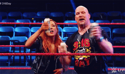 A Man And A Woman Are Standing In A Wrestling Ring With The Number 316 On Their Shirt GIF