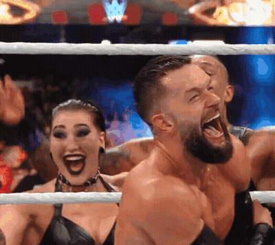 A Man And A Woman Are Standing In A Wrestling Ring With Their Mouths Wide Open GIF