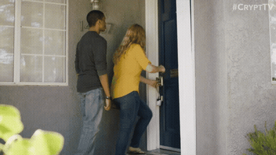 A Man And A Woman Are Standing In Front Of A Blue Door With #Crypttv Written On The Bottom Right GIF