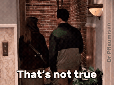 A Man And A Woman Are Standing In Front Of A Brick Wall And A Caption That Says That 'S Not True GIF