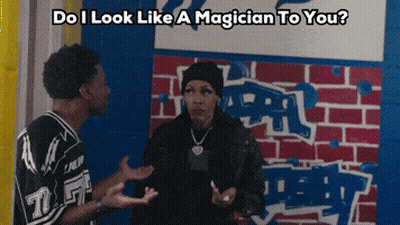 A Man And A Woman Are Standing In Front Of A Brick Wall With The Words " Do I Look Like A Magician To You " GIF