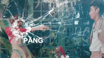 A Man And A Woman Are Standing In Front Of A Broken Glass Window With The Word Pang In The Corner GIF
