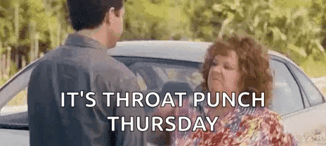 A Man And A Woman Are Standing In Front Of A Car And Talking . GIF